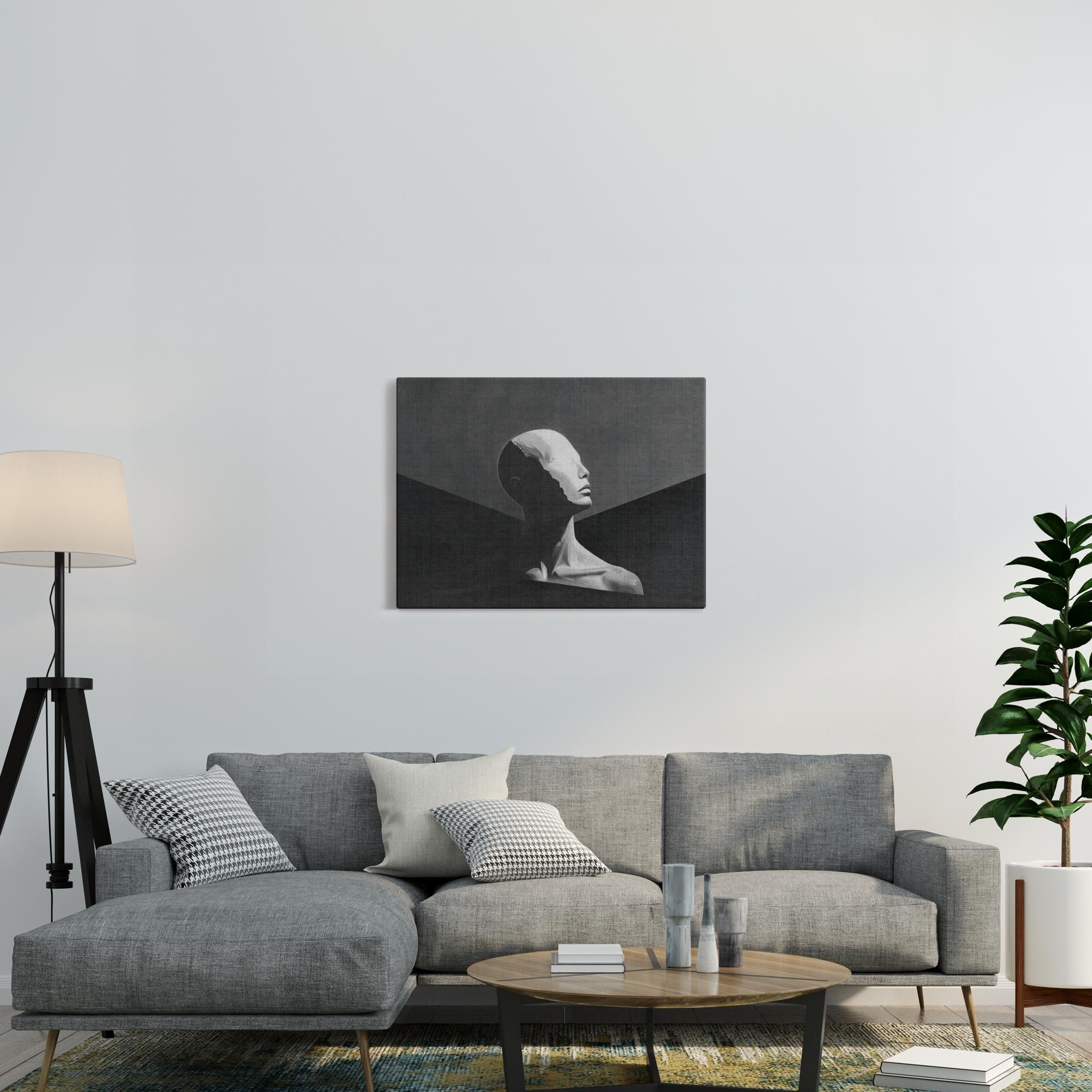 Human canvas print displayed above gray sofa in modern living room