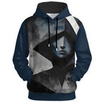 Geometric fragmented face with obscured features in moody blue-gray tones on statement hoodie